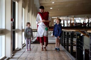 A young family are learning about Sussex history and Romans at Fishbourne Roman Palace 