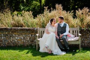 Relaxing outdoors at a barn wedding in Michelham Priory, East Sussex