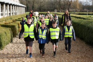 A school walking in the grounds of Fishbourne Roman Palace during a school history trip